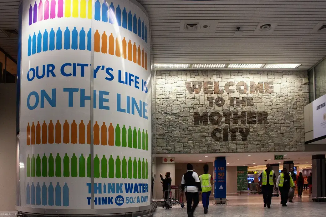 Advertisements in Cape Town encourage people to conserve water. Image by Brett Walton. South Africa, 2018.