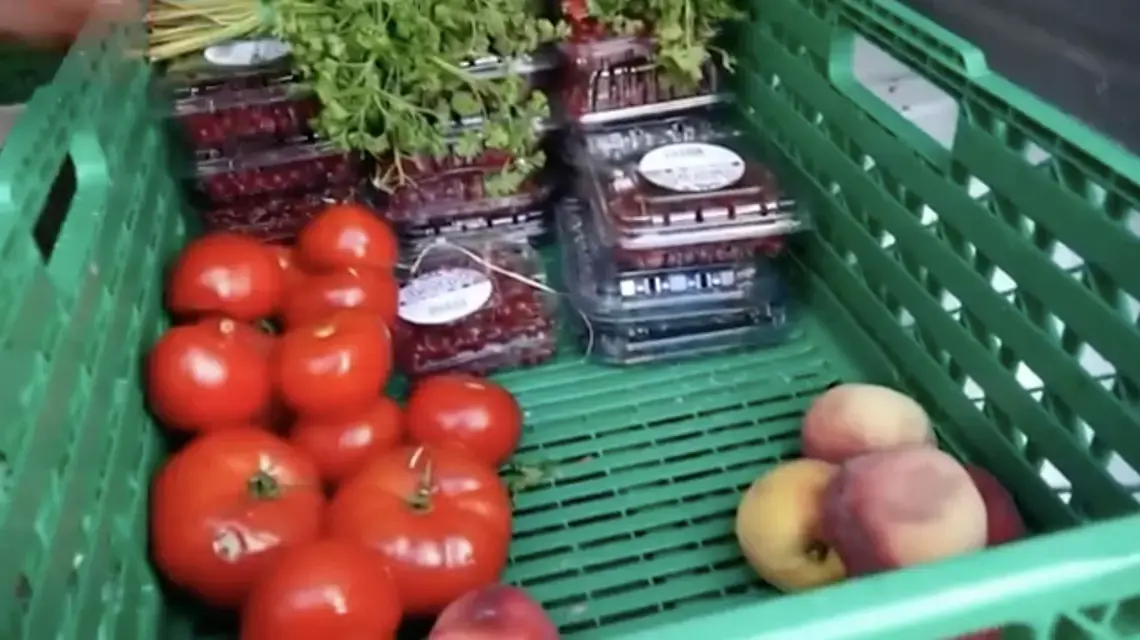 Bin of fresh produce being donated instead of thrown away at a French supermarket. Image by PBS NewsHour. France, 2019.