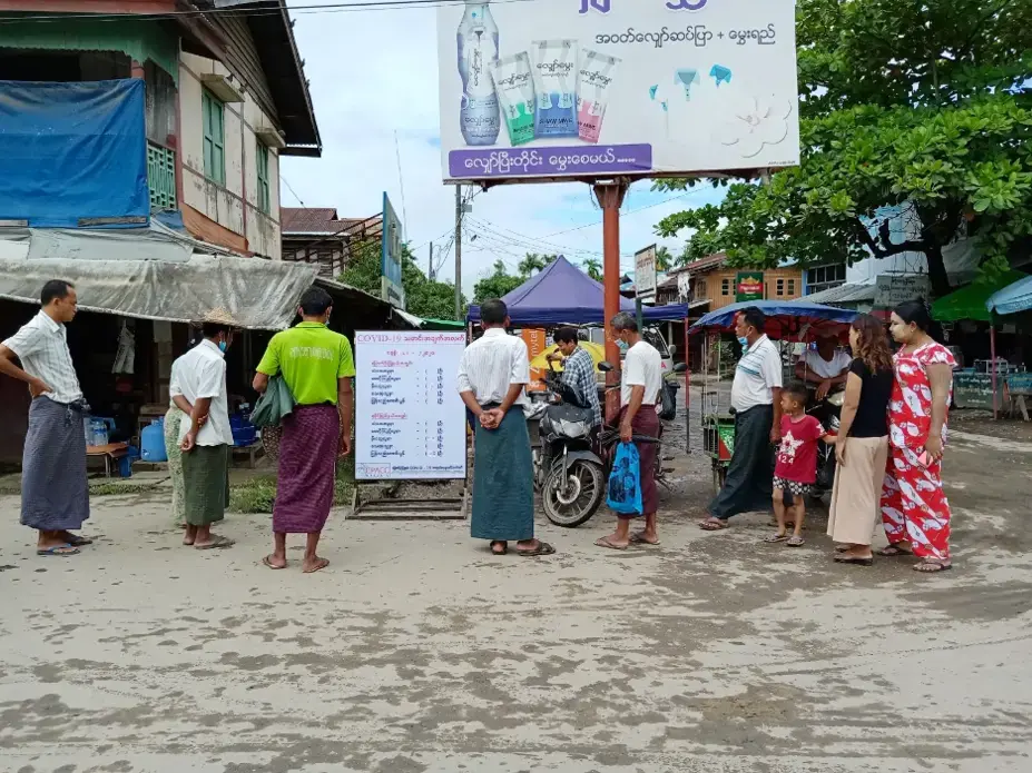 Residents of the town of Mrauk-U in Rakhine State, Myanmar gather around a COVID-19 information board created by a local civil society organization. Following a 14-month block on all internet services, the Myanmar government restored 2G services in August but continues to block 3G and 4G networks in eight conflict-affected townships, including Mrauk-U. Myanmar, 2020.