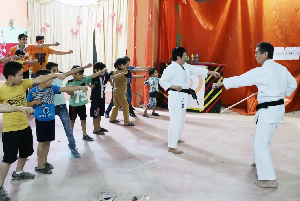 Local volunteers teach martial arts to young Syrian refugees at the Homs League Abroad in Amman. The center hopes such activities will bring positivity to the children's everyday lives. Image by Sawsan Morrar. Jordan, 2017.