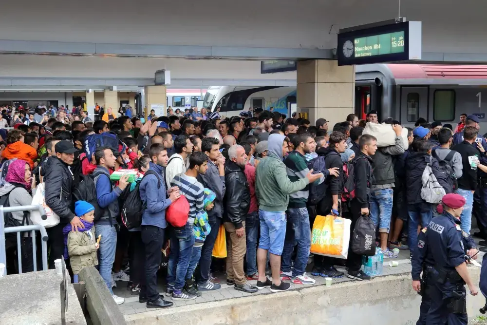 Migrants at Wien Westbahnhof railway station on their way to Germany. Image by Bwag courtesy Wikimedia Commons.  Austria, 2015.