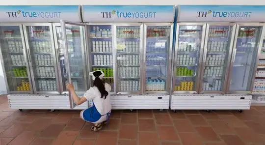 A worker takes care of inventory at a TH Truemart factory store in Nghia Son, Vietnam. Image by Mark Hoffman. Vietnam, 2019.