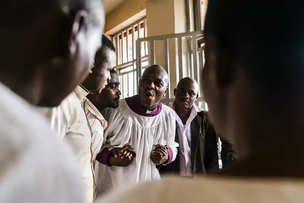 Tolton speaks with Ugandan pastors after a church service.&nbsp;Image by Jake Naughton. Uganda, 2017.
