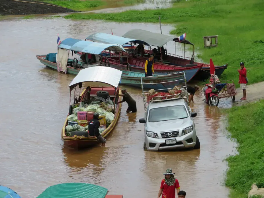 Fruit and vegetables being loaded onto boats in Chiang Khong, Thailand, for shipment across the Mekong River to Laos. Image by Richard Bernstein. Thailand, 2017.