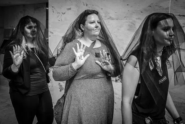 Women, many wearing black veils protesting the nomination of Brett Kavanaugh to the U.S. Supreme Court at the Hart Senate Office Building on Friday, September 7. Image by Phil Roeder. Washington D.C., 2018. (CC BY 2.0)