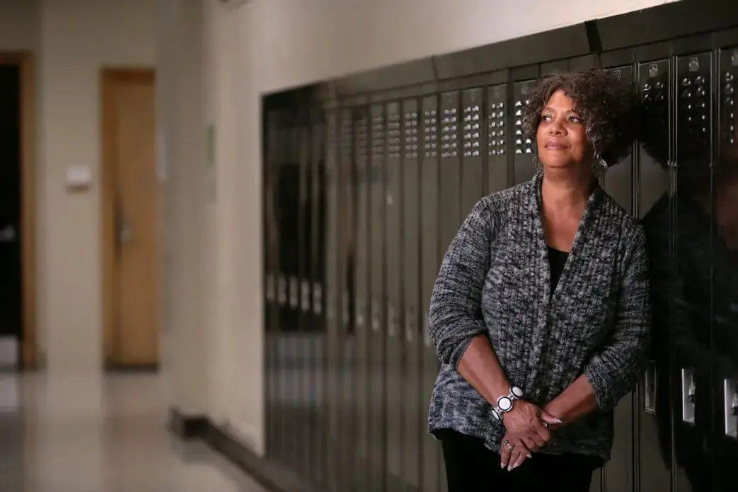 Judy Gladney, 67, poses for a portrait at University City High School. Gladney was among the first African-American students to integrate the high school. Image by Cristina M. Fletes. United States, 2019.