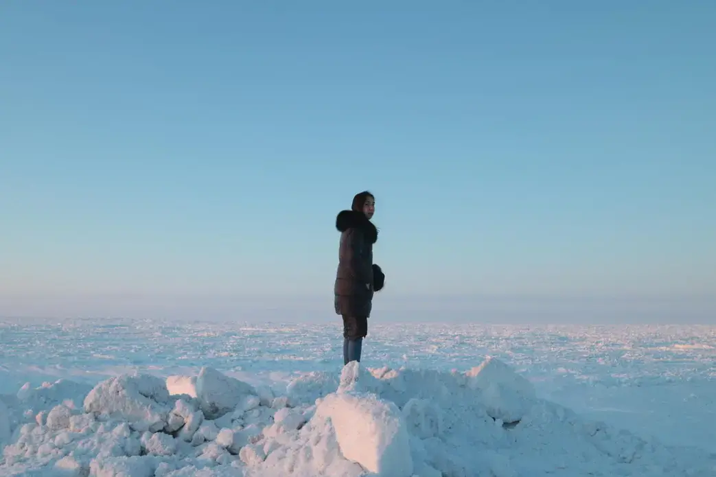 Coffee &amp; Quaq podcast host Alice Qannik Glenn overlooks the frozen Arctic Ocean in February. Image by Jenna Kunze. United States, 2020.