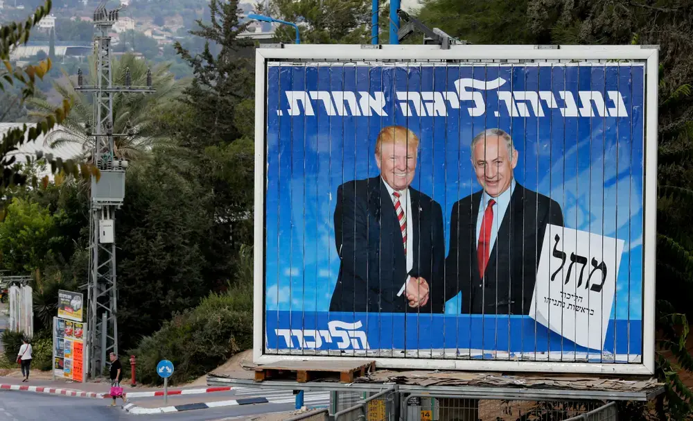 An Israeli election billboard for the Likud party showing President Donald Trump shaking hands with Israeli Prime Minister Benjamin Netanyahu in Beth Shemesh, Israel on September 8, 2019. Image by Gil Cohen Magen / Shutterstock. Israel, 2019.
