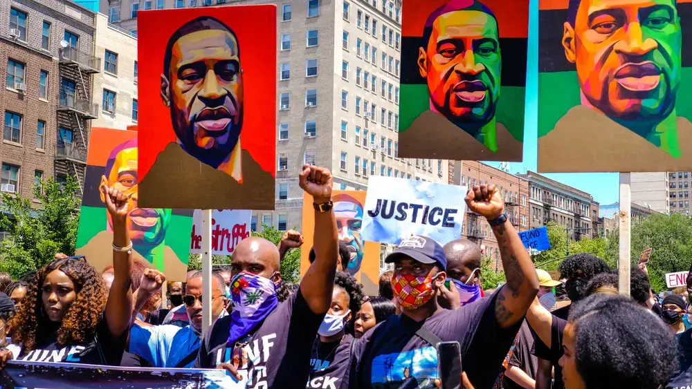 Marchers raise their fists at a justice rally for George Floyd and celebration of Juneteenth. Image by Fiora Watts / Shutterstock. United States, 2020.