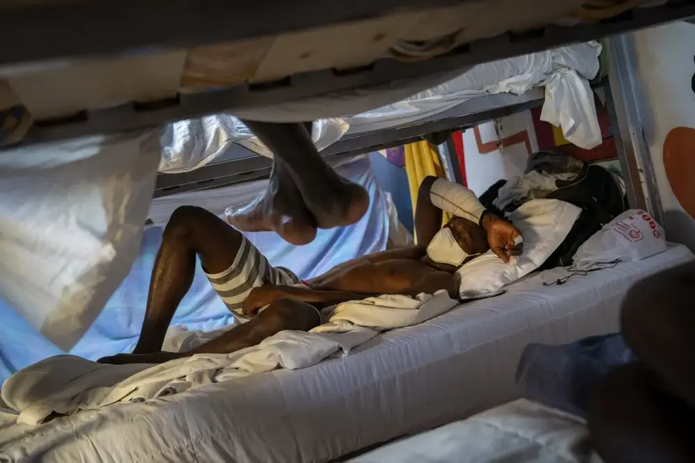 Hady Baye, 31, rests in a bunk bed at the Modern Christian Mission Church in Fuerteventura, one of the Canary Islands, Spain, on Saturday, Aug. 22, 2020.&nbsp;Image by Emilio Morenatti/AP Photo. Spain, 2020.