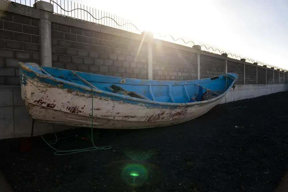 A wooden boat carrying the remains of migrant belongings is seen at the Arinaga port in Gran Canaria island, on Wednesday, Aug. 19, 2020.&nbsp;Image by Emilio Morenatti/AP Photo. Spain, 2020.