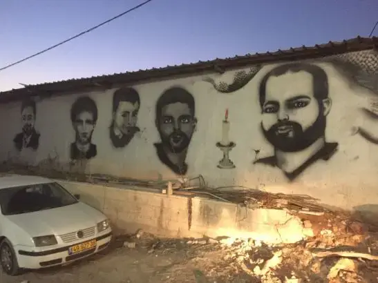 Murals of Palestinians killed by Israel decorate the walls around Qalandia village near the checkpoint. Image by Matt Kennard. West Bank, 2016.