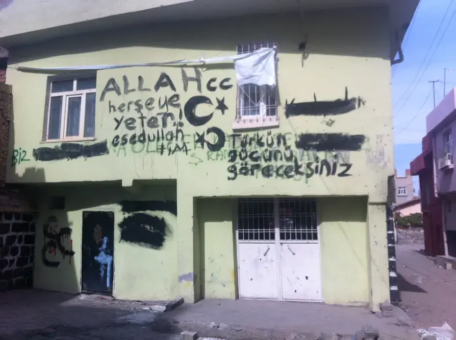 A graffiti-daubed house in the old walled city, in Diyarbakir, the main city in the Kurdish-majority southeast of Turkey. The graffiti says, 'you will see the strength of the Turk,' as well as exhortations to God, and was left by Turkish soldiers who recently fought running battles with Kurdish nationalists who had declared the walled city an autonomous zone. Image by Christopher de Bellaigue. Turkey, 2015.
