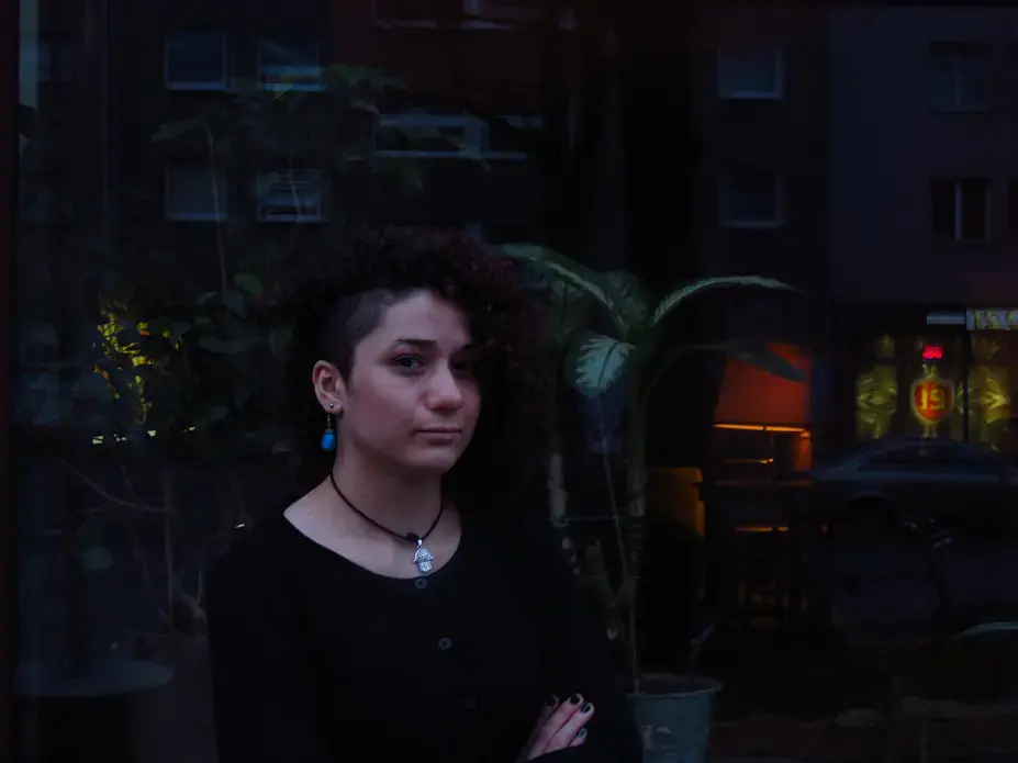Roshak, a Kurdish-Syrian refugee, poses in front of a trendy cafe in Berlin's Kreuzberg neighborhood. Image by Laura Kasinof. Berlin, 2016.