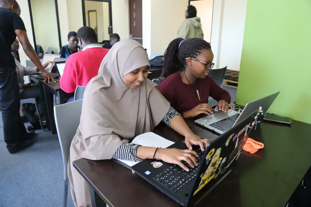 Two students at the Moringa School based in Nairobi work on developing their coding skills. Image by Janelle Richards. Kenya, 2017.