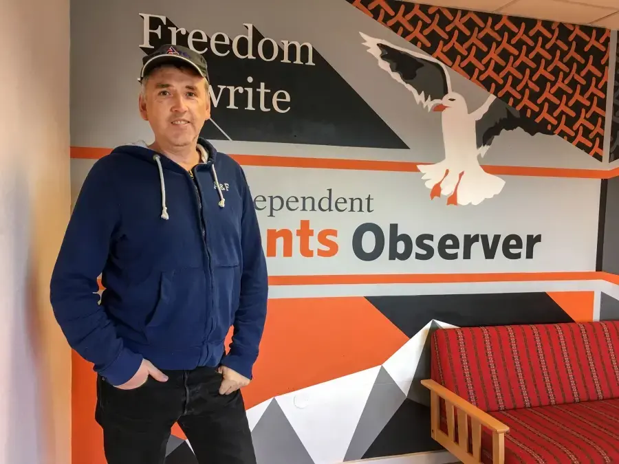 Journalist Thomas Nilsen poses for a photo in the offices of The Barents Observer in Kirkenes, Norway. The newspaper publishes in both English and Russian and covers environmental issues in the Russian Arctic. Nilsen recently found out he was no longer welcome in Russia and he's been fighting the decision in Russian courts. Image by Amy Martin. Norway, 2018.
