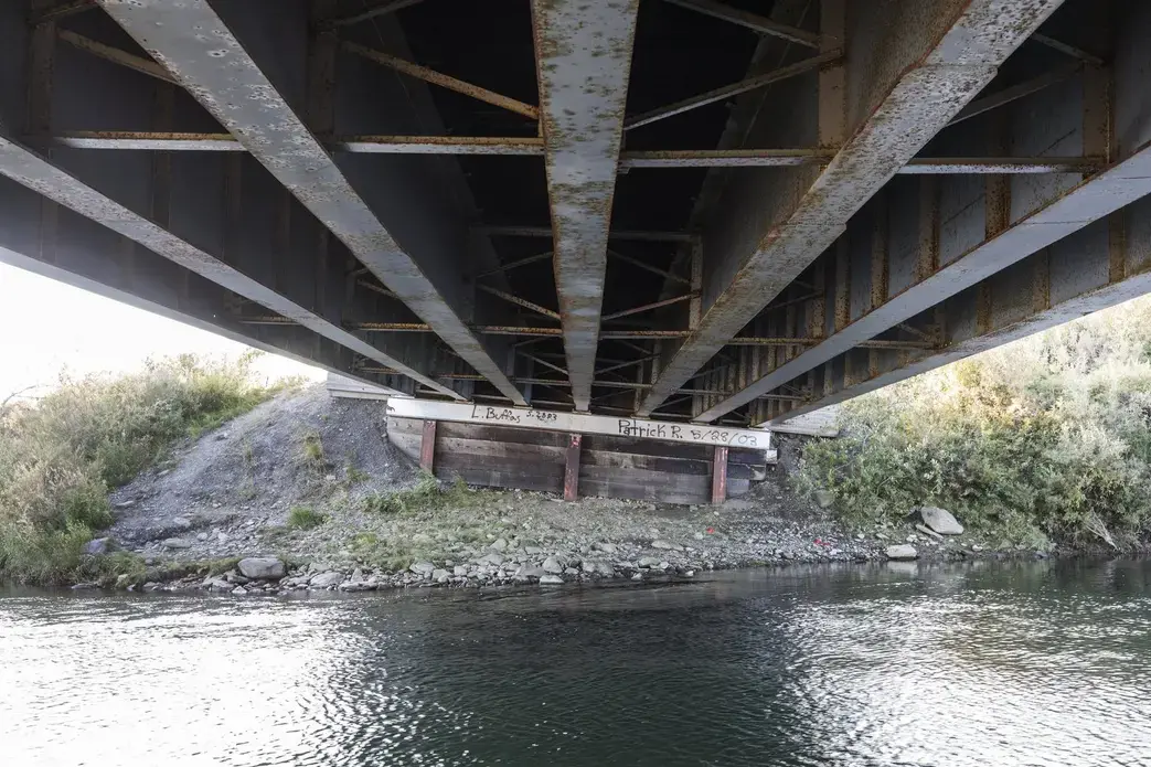 Thawing permafrost has caused a tilt on the pilings that support this bridge on the Nome-Teller Highway, requiring increased maintenance as the Northwest Alaska climate warms. Image by Steve Ringman. United States, 2019.
