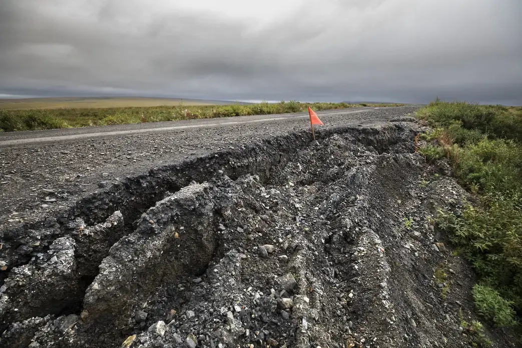 In a warming Northwest Alaska climate, maintenance costs are mounting on this 73-mile road that connects Nome to the community of Teller. Permafrost under this route is thawing, causing settling, cracking and sloughing that require more frequent repairs. Image by Steve Ringman. United States, 2019.