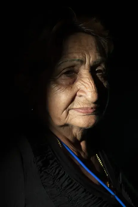 Doña Chuli, a.k.a. La Sucha (The Vulture), a paiche merchant in Riberalta, has built a thriving family business on the invasive fish. “I felt—and I still feel—that it was a gift from god,' she says. 'A lot of people here have their work thanks to this fish.' Image by Felipe Luna. Bolivia, 2018.