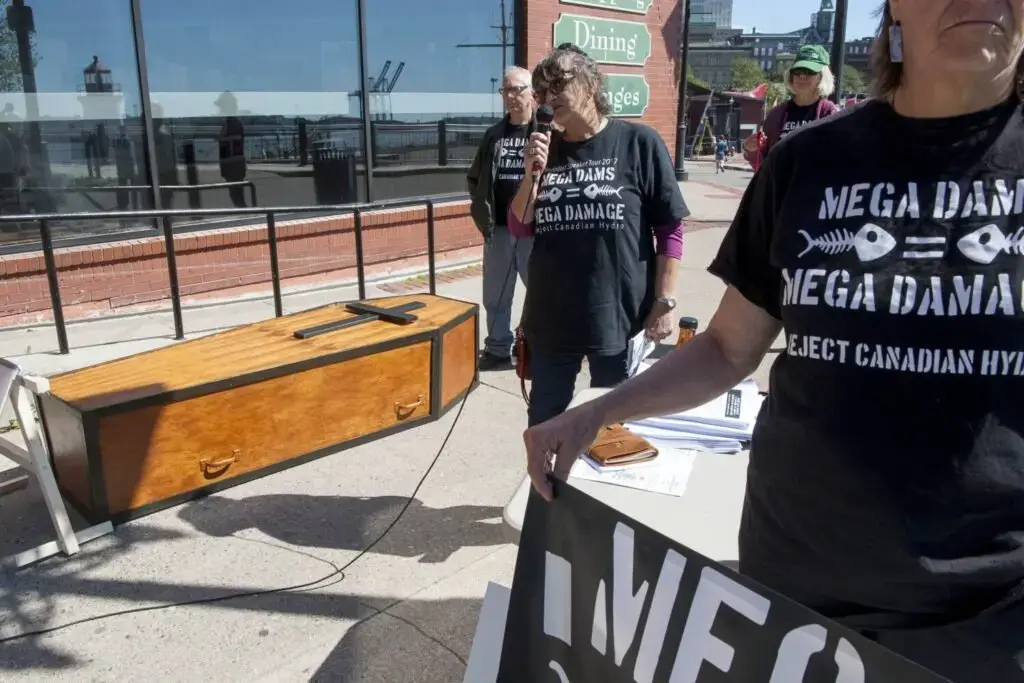Roberta Benefiel-Frampton, center, talks about the dangers of mega-dam hydropower during a protest of Nalcor, Central Maine Power and HydroQuebec in Saint John, New Brunswick, Canada, on Sept. 8, 2019. Image by Michael G. Seamans. Canada, 2019.