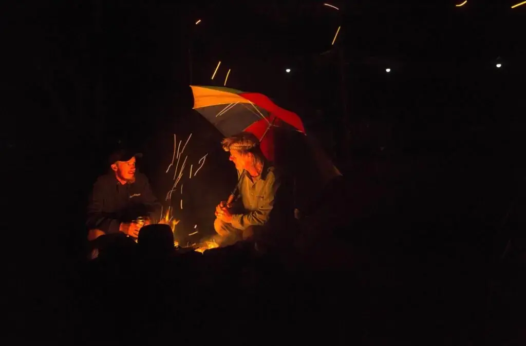 Duane Hanson talks with his oldest son, Yule, during a family camping trip at Spencer Lake in T3 R5, in the Unorganized Territories of Maine, on Aug. 3, 2019. The camping trip is an annual family retreat close to the Hanson homestead. Image by Michael G. Seamans. United States, 2019.