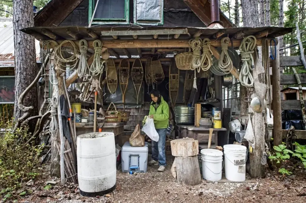 Sally Kwan packs up some fresh broccoli in the outdoor kitchen used during the summer months in T5 R7 in the Unorganized Territories on Sept. 17, 2019. Image by Michael G. Seamans. United States, 2019.