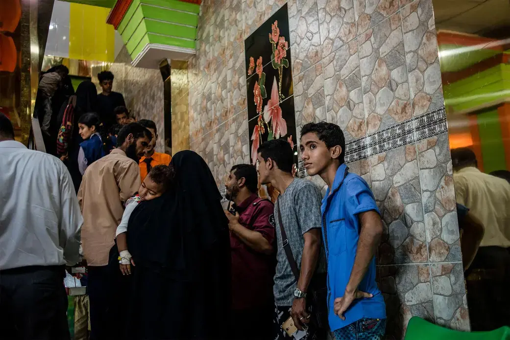 Hamza waits for a table before lunch. Image by Alex Potter. Yemen, 2018.
