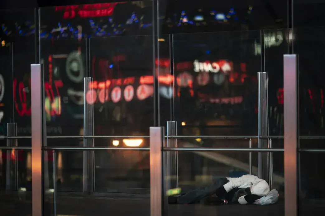 A homeless person sleeps on an overpass along the Las Vegas Strip, Wednesday, Nov. 11, 2020. Image by Wong Maye-E / AP Photo. United States, 2020.