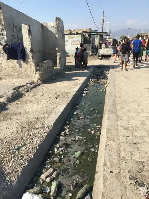 Street in Cite Soleil, a slum of Port-au-Prince. Image by Kate Corrigan. Haiti, 2017.<br />
