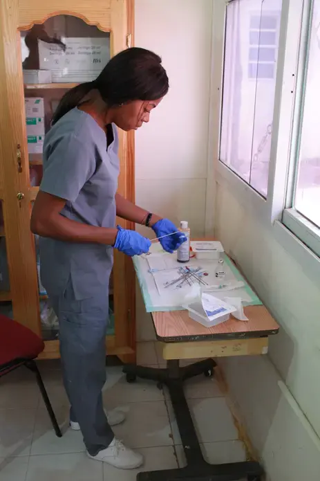 A nurse at the IHI offices prepares instuments for a breast biopsy.&nbsp;Image by Kate Corrigan. Haiti, 2017. 