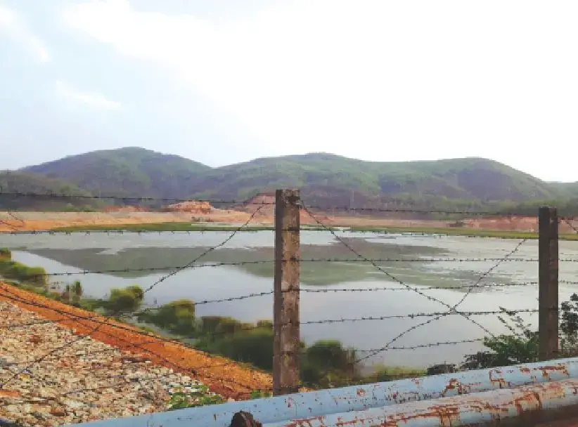 Image of a pond behind a fence.