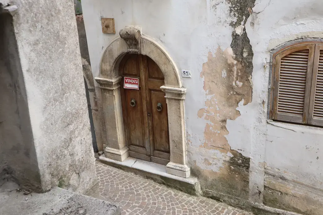 for sale sign on ancient door