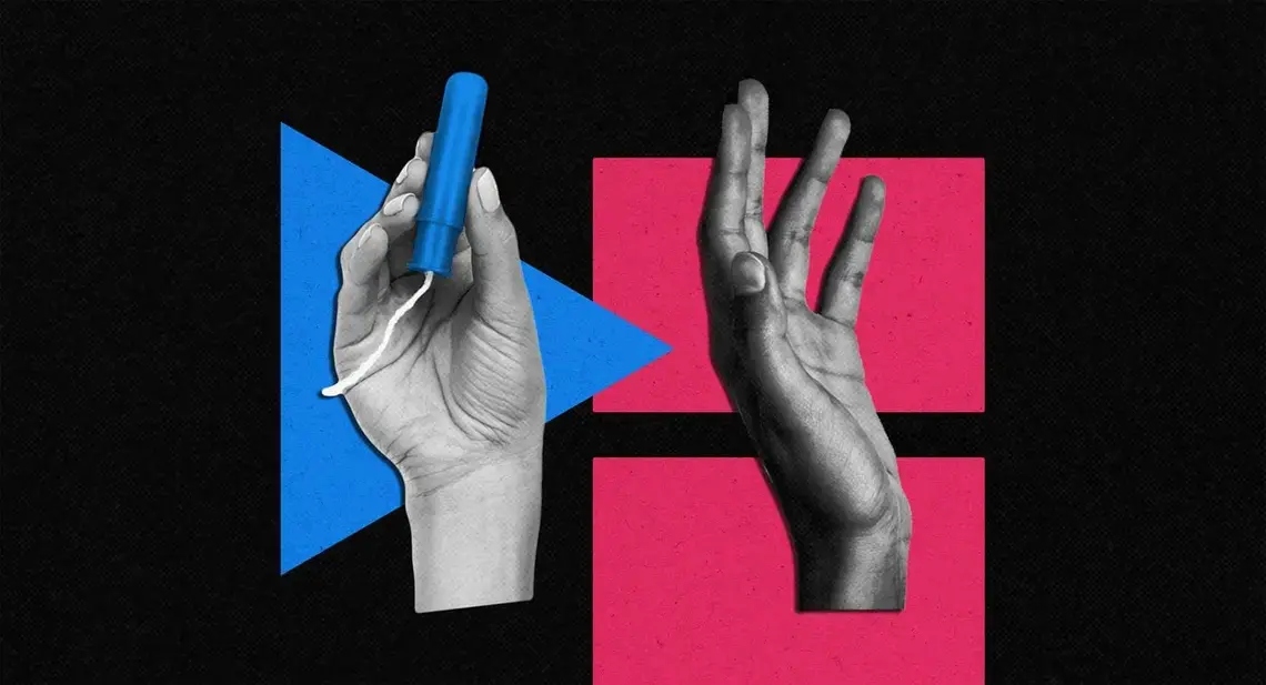 a hand holding a tampon