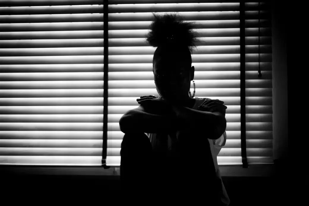woman's shadow in window
