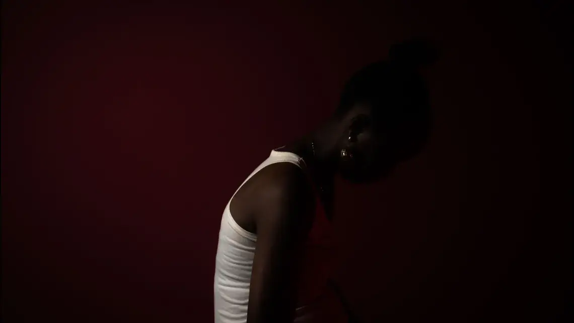 person shrouded in shadows