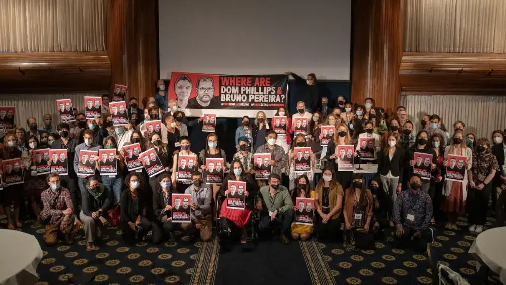 Pulitzer Center staff members, grantees, and Fellows hold "Where are Dom Phillips &amp; Bruno Pereira?" posters at the Center's annual conference, Interconnected: Reporting the Climate Crisis.