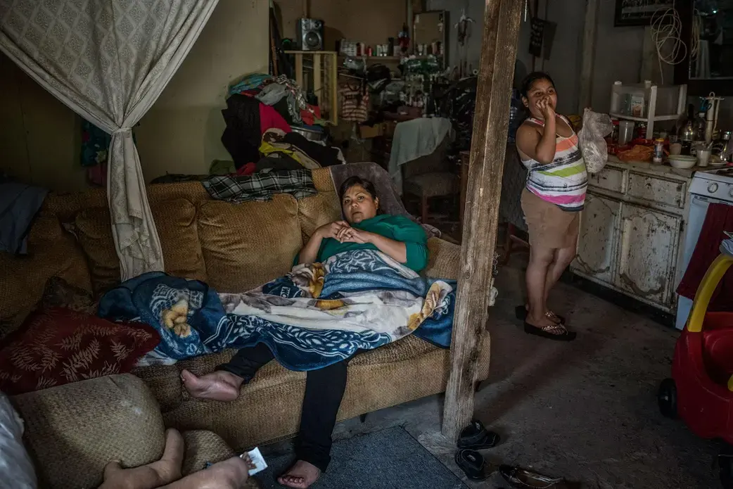 A family near Otay Canyon backs up against the border wall. Their biggest worry now is the impending plan to build a highway through the area. Their house would sit directly in its path. Image by James Whitlow Delano. Mexico, 2017.