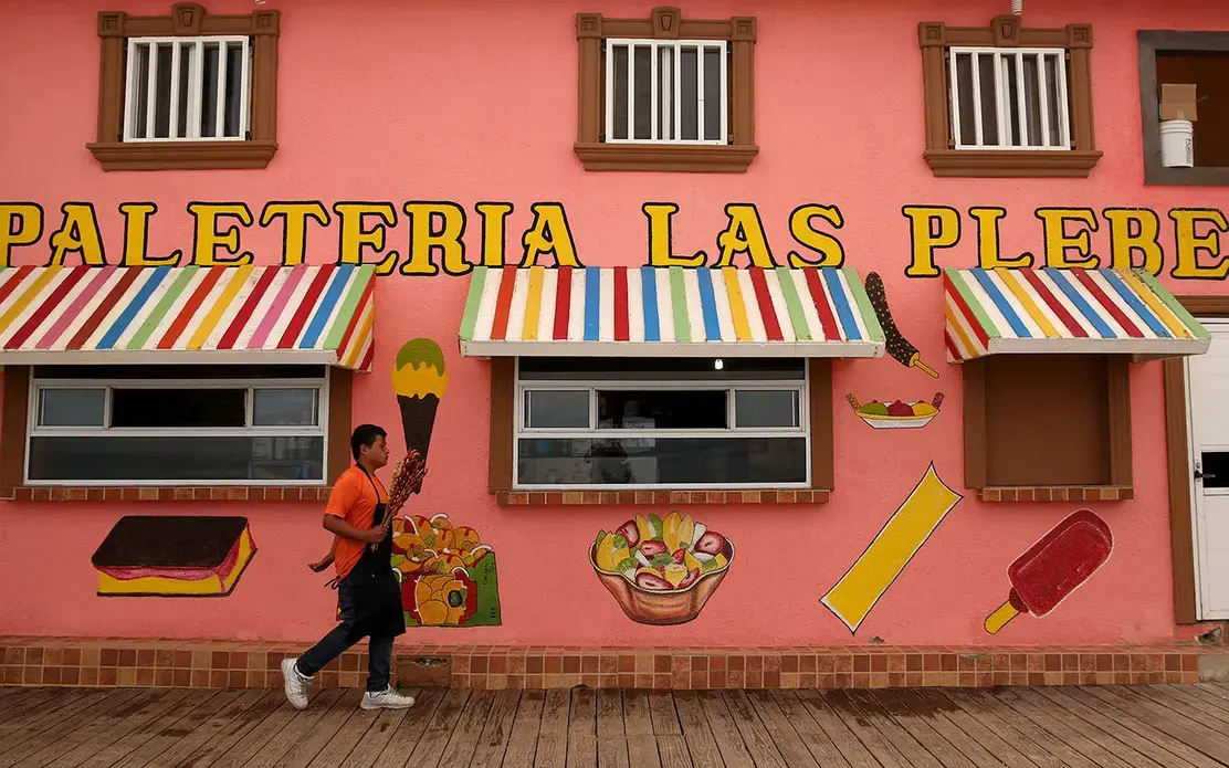 Jimmy, 12, sells shrimp at the beach in Tijuana. Jimmy went against his mother’s wishes and found a job to help with their bills. Image by Erika Schultz. Mexico, 2019.