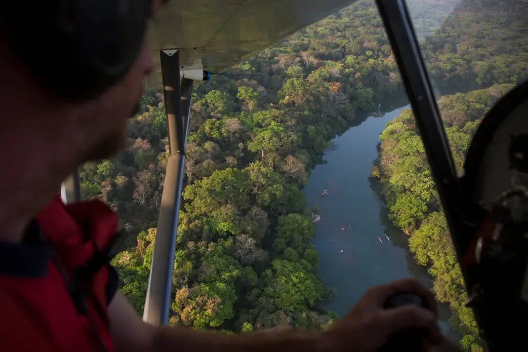The River Chinko winds through the south of this vast park, surrounded by lush tropical forest. In its waters are fish, crocodiles and hippo - all attractive targets for poachers who sneak into the reserve. Image by Jack Losh. Central African Republic, 2018.
