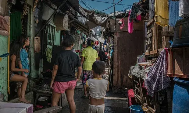 A deeply worried, Remy Fernandez (wearing a yellow T-shirt), asks if anyone has seen her daughter-in-law, Lourdes, who was missing after being released from prison on drug charges. She is looking after seven grandchildren since her son was executed. Image by James Whitlow Delano. Philippines, 2018. 