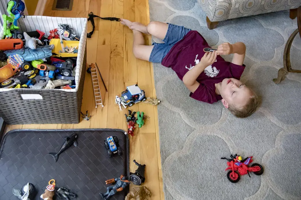 Elias Camacho, 4, plays with toys in the living room of his home in Swannanoa on June 30, 2020. Elias recently had to switch child care centers after the one he was attending closed due to low enrollment after the COVID-19 pandemic. Image by Angeli Wright/Asheville Citizen Times/North Carolina News Collaborative. United States, 2020.</p>
<p>