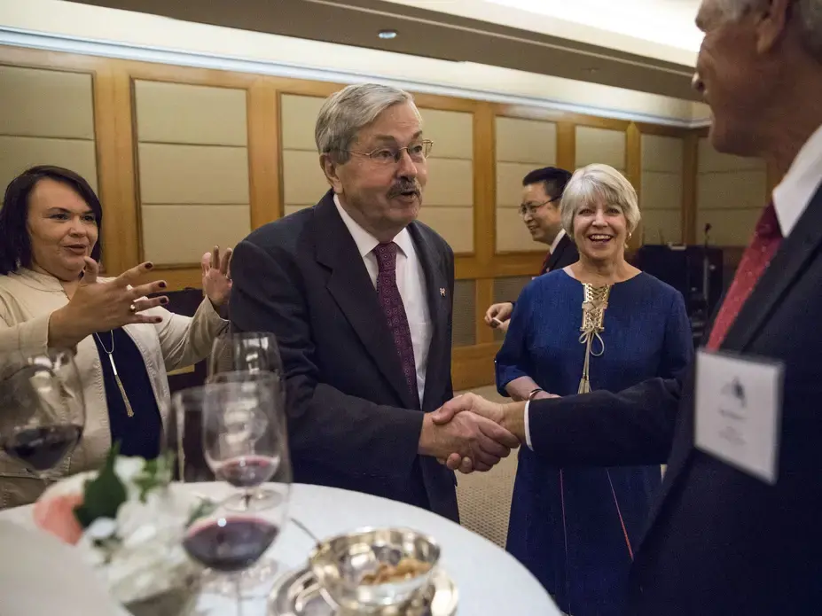 U.S. Ambassador to China Terry Branstad shakes hands with Rick Kimberley, a farmer from Maxwell, Iowa, on Wednesday, Sept. 20, 2017, during an Iowa Sister States reception in Beijing. Kimberley was in China to attend the groundbreaking of the China-U.S. Demonstration Farm, which is being modeled after his farm in central Iowa. Image by Kelsey Kremer. China, 2017.