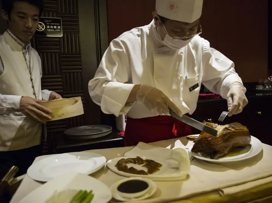 Beijing Duck, a famous preparation of duck, is served for dinner in Beijing, on Thursday, Sept. 21, 2017, in China's capital city. Image by Kelsey Kremer. China, 2017.