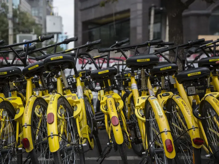 Rental bikes are parked in rows at a busy intersection on Wednesday, Sept. 27, 2017, in Beijing, China. Bikes like these are plentiful and available to rent all over the city. Image by Kelsey Kremer. China, 2017.
