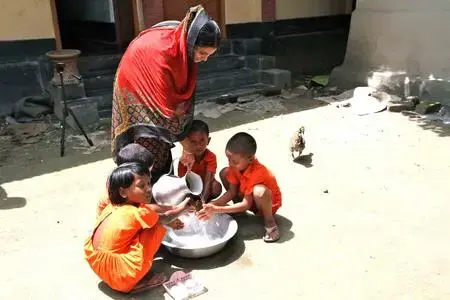Children wash hands at a child development center in Monohardi, Bangladesh. The centers are called "anchals," from the end piece of a sari mothers use to cover and carry their children (Photo by Jon Sawyer).