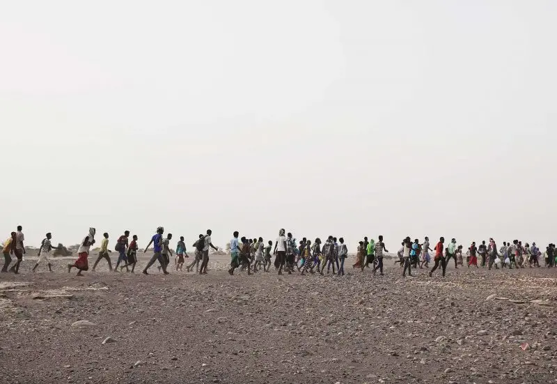 Ethiopian migrants are led by smugglers in Obock, Djibouti, July 14, 2019, prior to crossing the Bab el-Mandeb strait to Yemen. Image by AP Photo / Nariman El-Mofty. Djibouti, 2019.