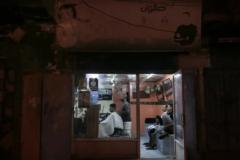 In this Feb. 16, 2018, photo, 18-year-old Abdullah gets his hair cut at a barbershop in Aden, Yemen. Even with a civil war in full swing, people seek some simple recreations and acts of normal life—such as this young man’s haircut. Women visit salons where a blow-dry costs 200 Yemeni Riyals ($0.80). Image by Nariman El-Mofty. Yemen, 2018. </p>
<p>