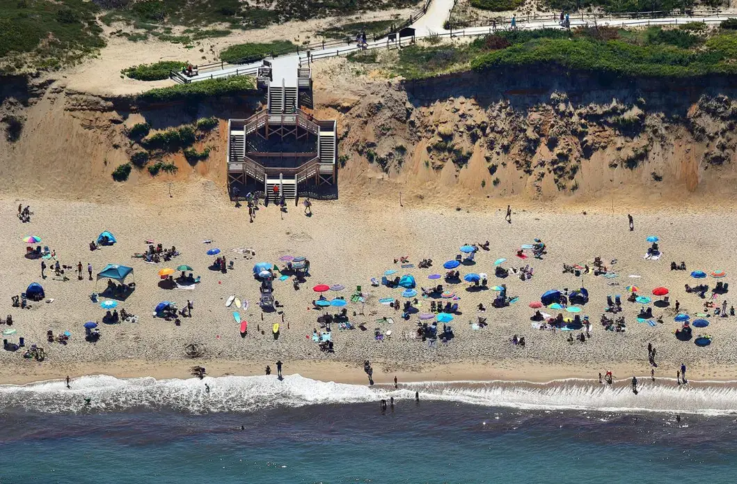 Erosion along the cliffs of Marconi Beach. The staircase was rebuilt and opened in May of 2019 after storms damaged it in the fall of 2018. Image by John Tlumacki. United States, 2019.