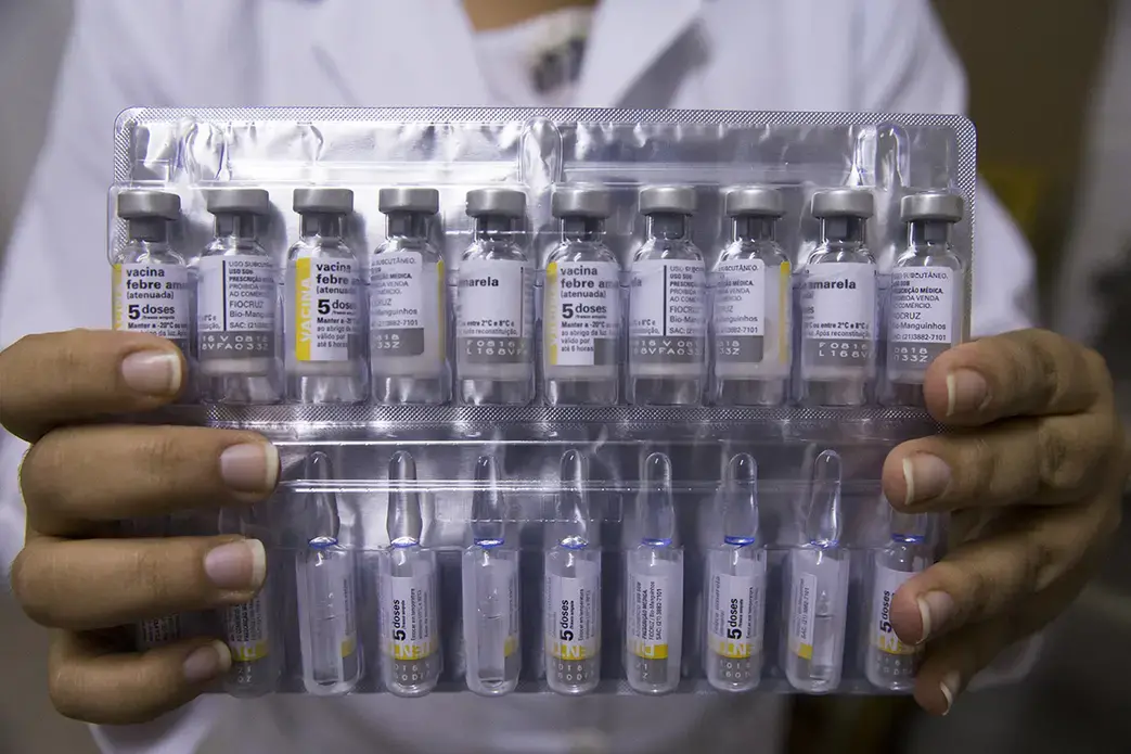 Tielly Barboga de Souza holds packages of vaccine at a public health clinic. Each immunization for yellow fever cost about $1 at the clinic. Image by Mark Hoffman. Brazil, 2017.