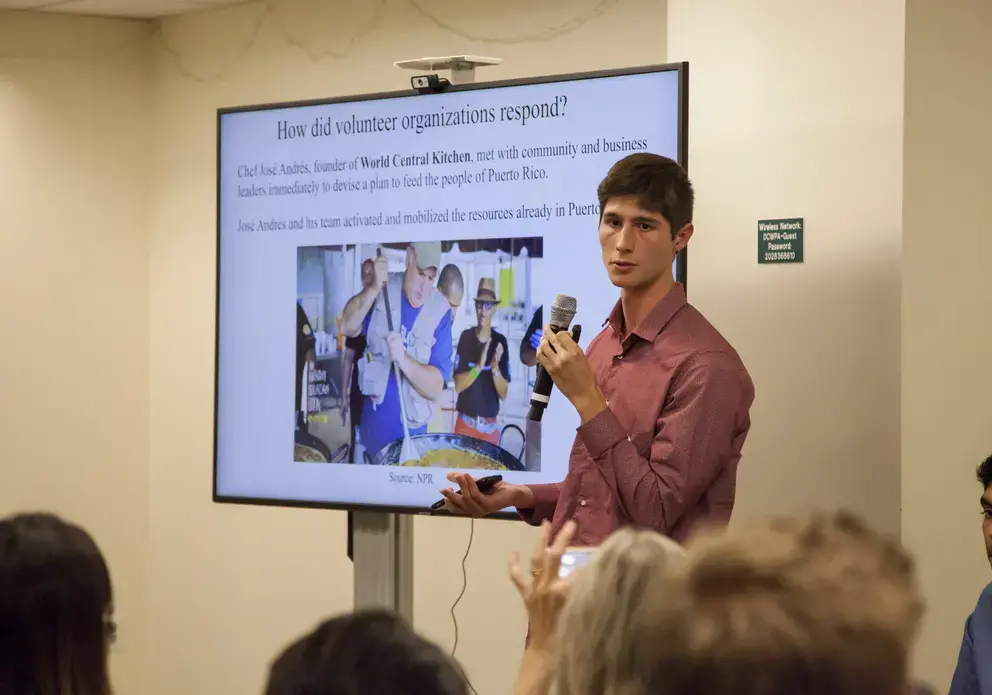 Tomas Woodall Posada (Forsyth Technical Community College) presents his global reporting project at 2018 Washington Weekend. Image by Jin Ding. United States, 2018.